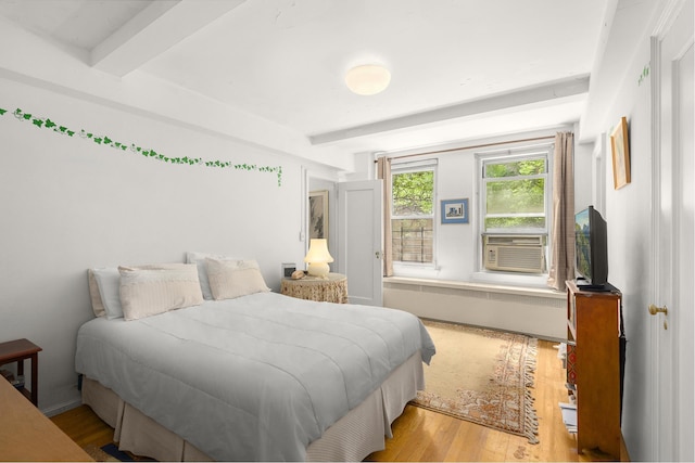 215 E 73rd St Unit 3C, New York City, NY 10021 - bedroom with beamed ceiling, wood finished floors, and cooling unit