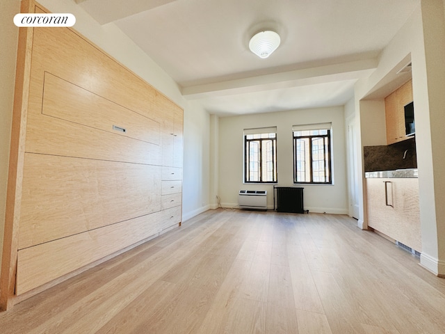 unfurnished living room featuring baseboards and light wood-style flooring
