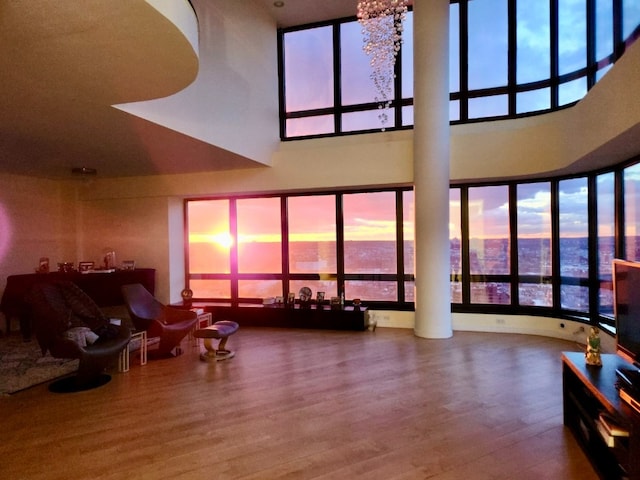 living room featuring a high ceiling and wood finished floors