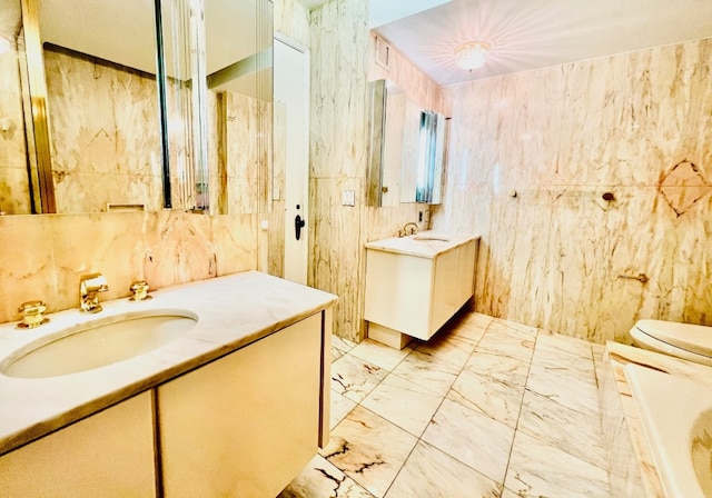 bathroom featuring toilet, tile walls, and vanity