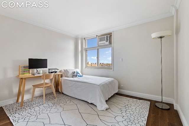 bedroom with a wall mounted AC, crown molding, and hardwood / wood-style flooring