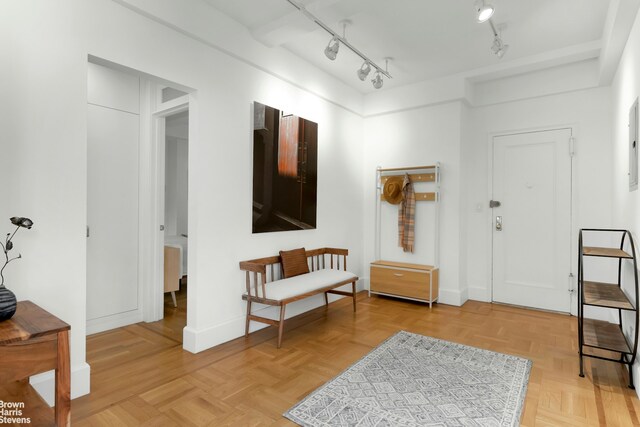 bedroom with ensuite bathroom, ceiling fan, beam ceiling, and light wood-style floors