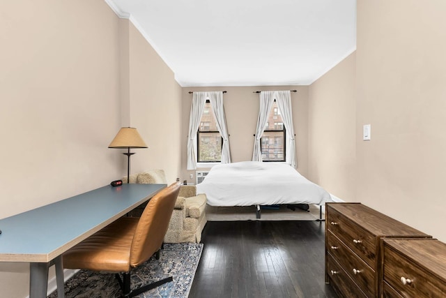 bedroom with dark wood-style flooring and crown molding