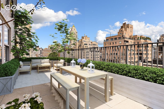 view of patio / terrace featuring a view of city and outdoor lounge area