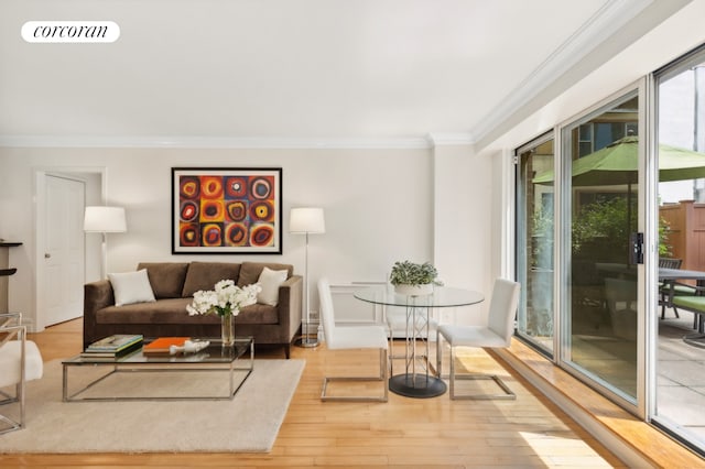 living room with visible vents, crown molding, and wood finished floors