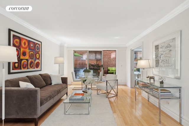 living room featuring baseboards, wood-type flooring, visible vents, and crown molding