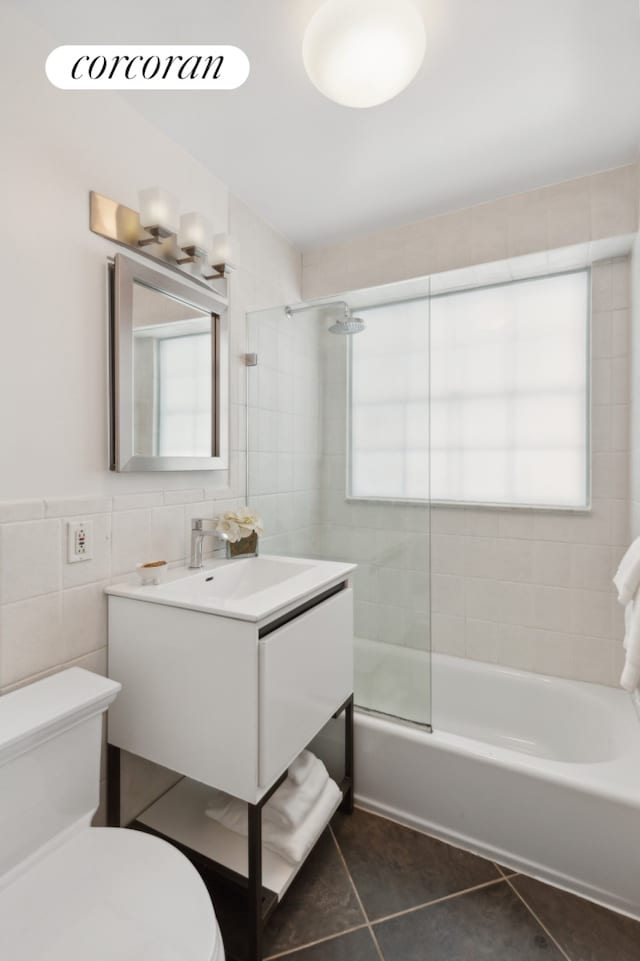 137 E 36th St Unit 2C, New York City, NY 10016 - full bath with vanity, plenty of natural light, tile patterned floors, shower / tub combination, and tile walls