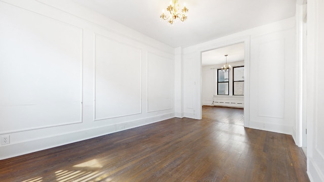 unfurnished room with dark hardwood / wood-style flooring, a baseboard heating unit, and a chandelier