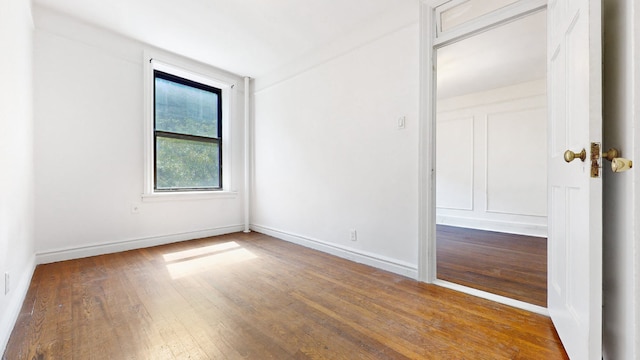 unfurnished room featuring hardwood / wood-style floors