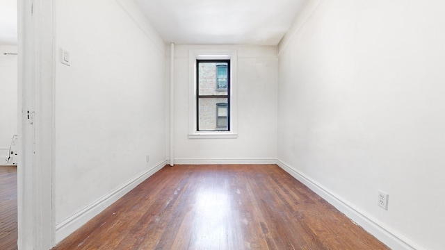 empty room with dark wood-type flooring