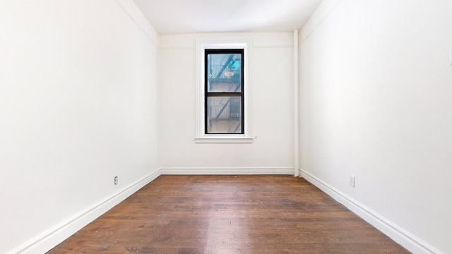 unfurnished room featuring dark hardwood / wood-style flooring