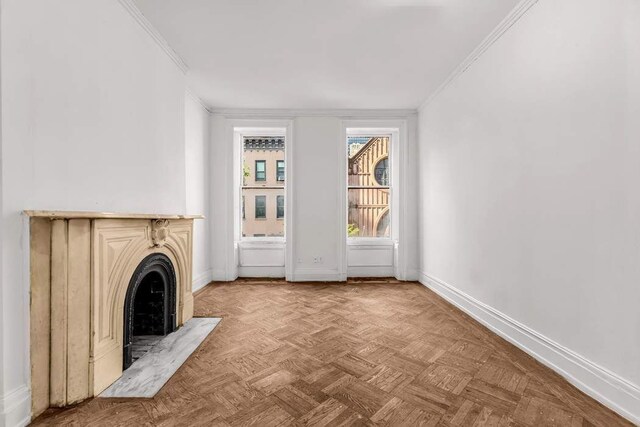 unfurnished living room with crown molding