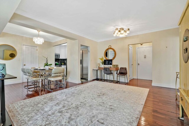 dining space with a chandelier, dark wood finished floors, baseboards, ornamental molding, and an office area