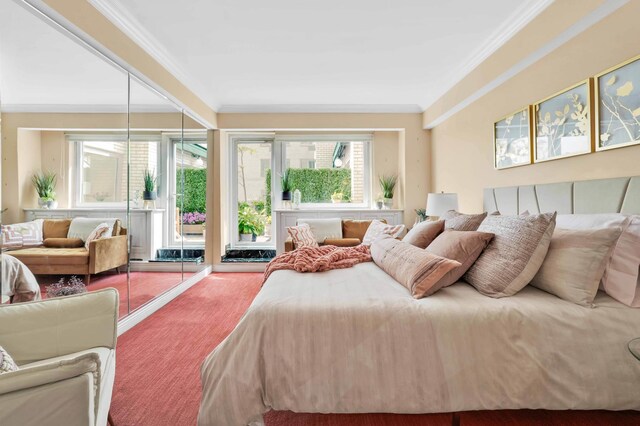 bedroom with ornamental molding and carpet flooring