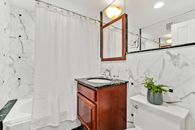 full bath with tile walls, vanity, toilet, and shower / tub combo with curtain