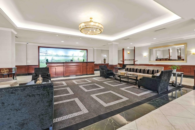 building lobby featuring a wainscoted wall, crown molding, and recessed lighting