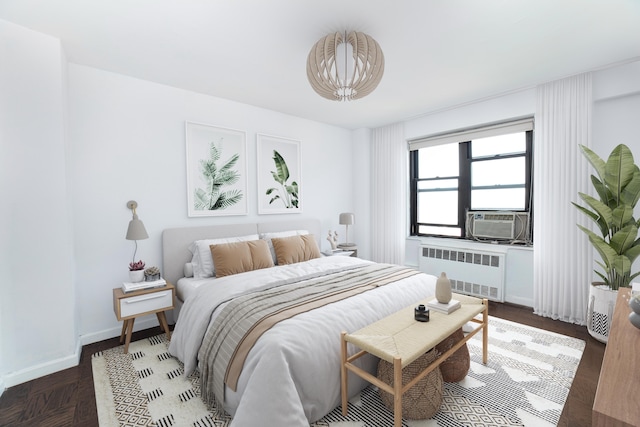 bedroom featuring cooling unit, radiator, and baseboards