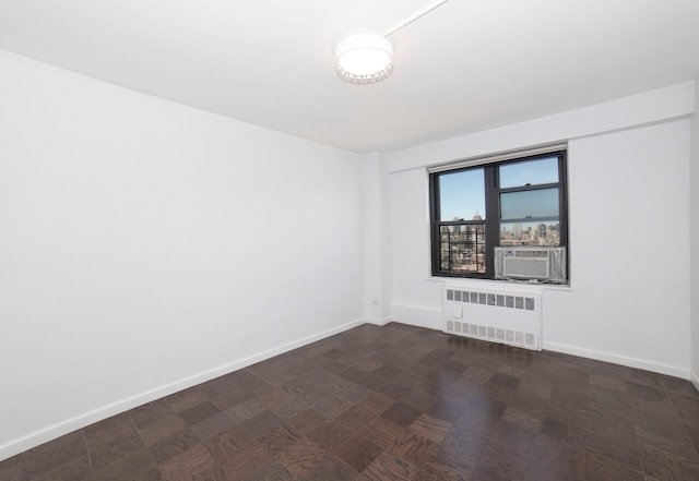 210 E Broadway Unit H1904, New York City, NY 10002 - spare room with radiator, baseboards, and cooling unit