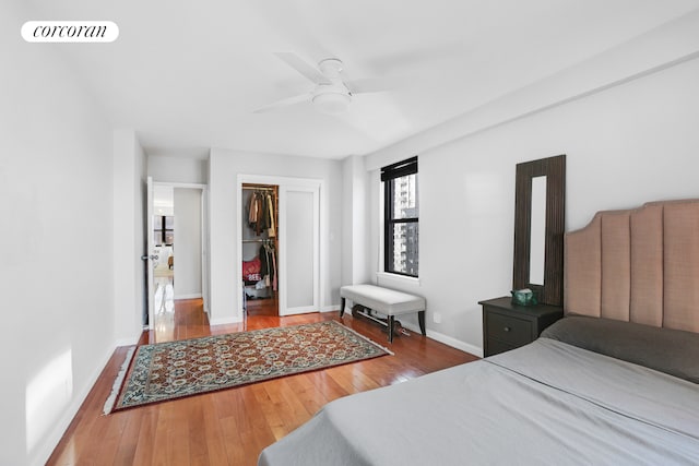 bedroom featuring a closet, wood-type flooring, visible vents, and baseboards