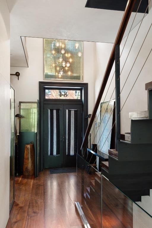 entryway with dark hardwood / wood-style floors and a chandelier