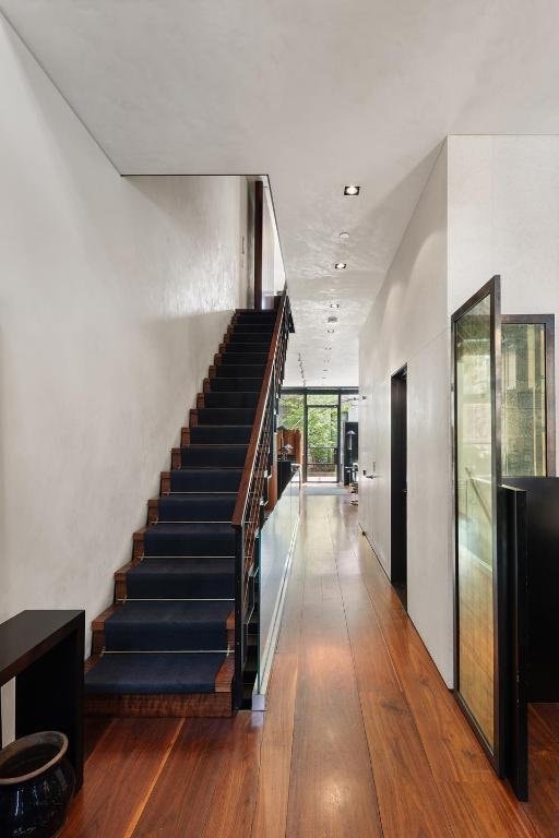 interior space featuring a wall of windows and hardwood / wood-style floors