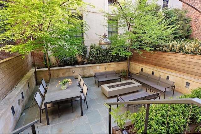 view of patio / terrace featuring an outdoor living space with a fire pit