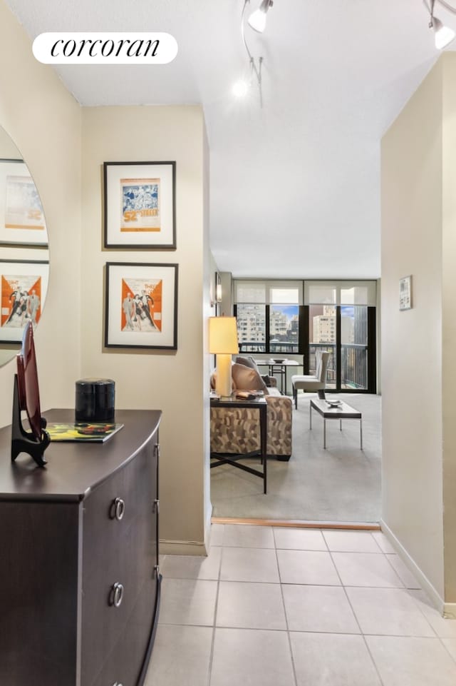 hall with light tile patterned floors and baseboards