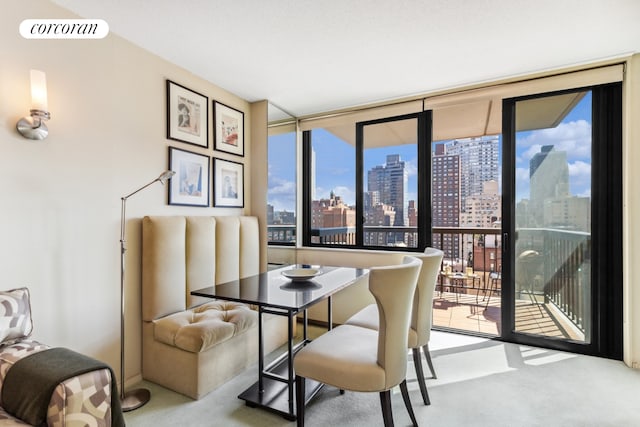 dining area with a city view, carpet flooring, and visible vents