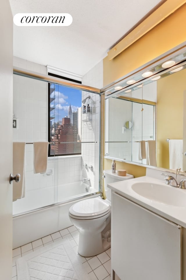 bathroom with toilet, a city view, shower / bath combination with glass door, and tile patterned flooring