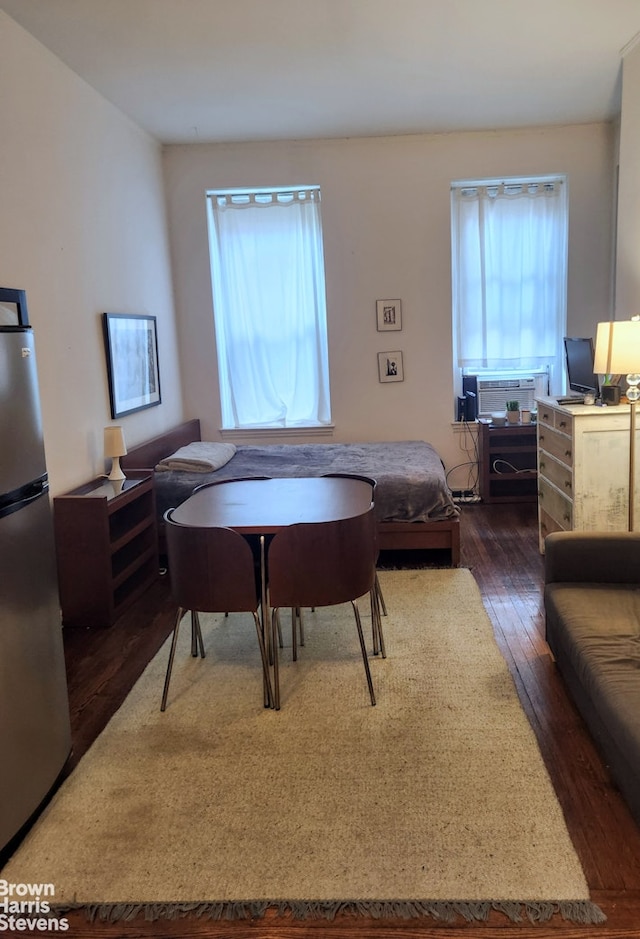 bedroom featuring dark wood-type flooring and freestanding refrigerator