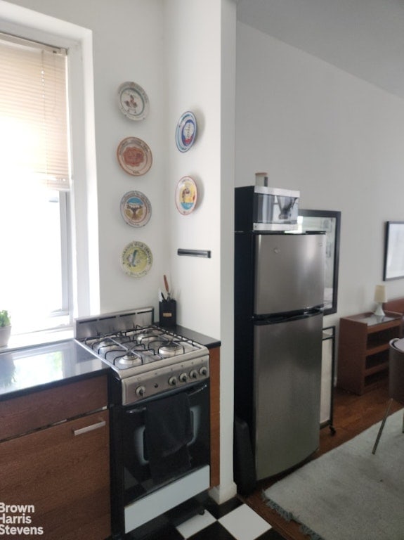 kitchen featuring stainless steel fridge and gas stove