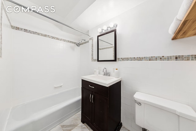 full bath with toilet, marble finish floor, shower / bathing tub combination, tile walls, and vanity