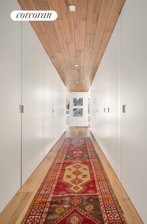 hall featuring wood finished floors and wood ceiling