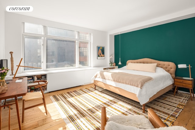 bedroom featuring light wood finished floors and visible vents