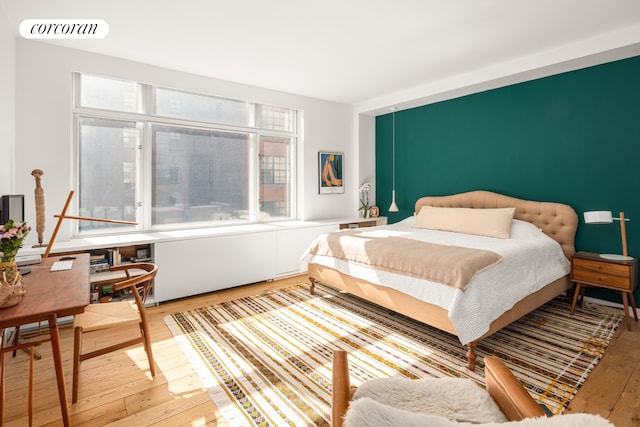 bedroom featuring wood-type flooring and visible vents