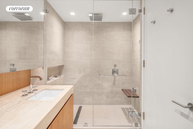 bathroom with a shower stall and vanity