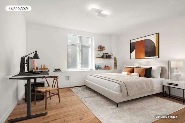 bedroom with baseboards, visible vents, and light wood finished floors