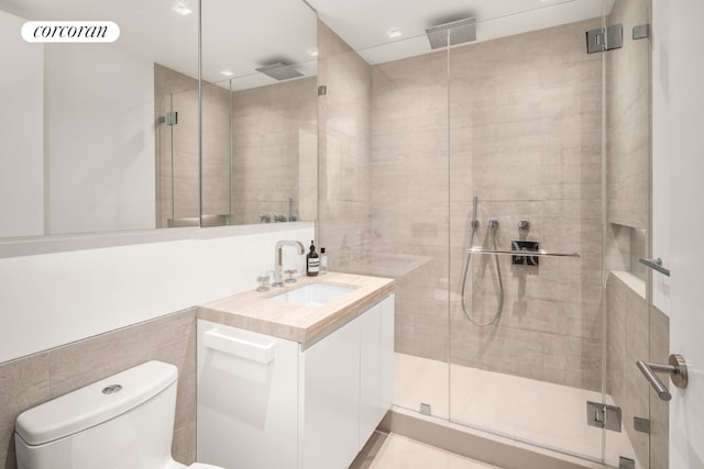 full bathroom with toilet, a shower stall, visible vents, and vanity