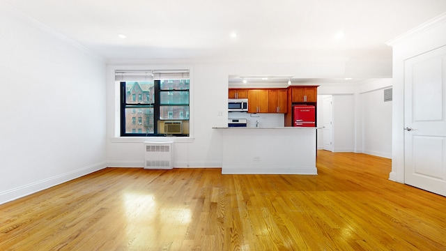 unfurnished living room with radiator, ornamental molding, light wood-style floors, baseboards, and cooling unit