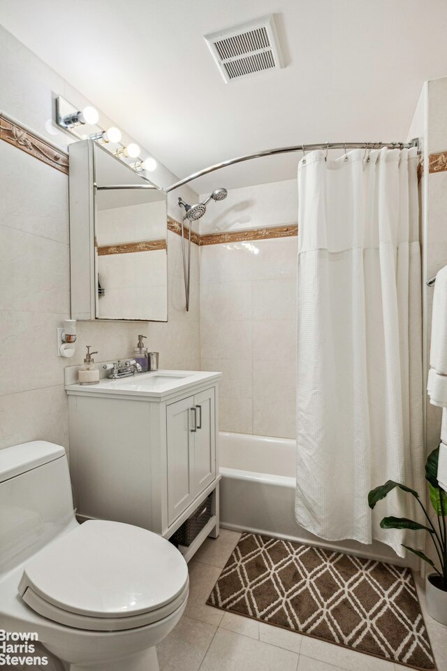 full bathroom featuring visible vents, toilet, shower / bath combo, vanity, and tile patterned floors