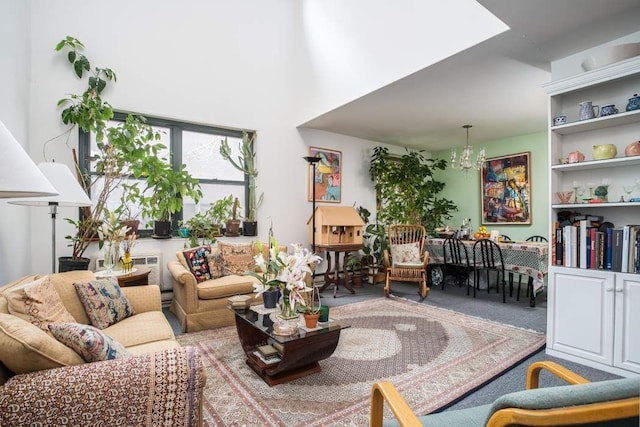 living room with a notable chandelier, a skylight, and carpet