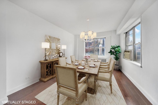 dining room with hardwood / wood-style flooring, an inviting chandelier, and cooling unit