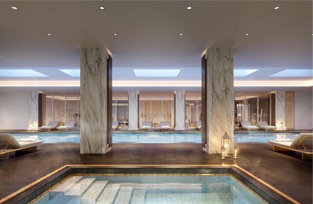 view of swimming pool featuring a skylight