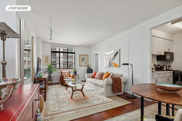 living room featuring visible vents, wood finished floors, and track lighting