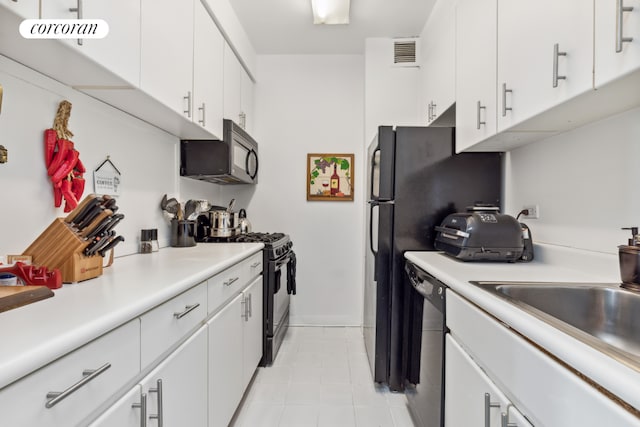 kitchen with sink, white cabinets, and black appliances