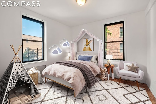 bedroom featuring multiple windows and wood-type flooring