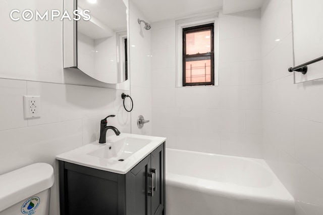 bathroom featuring tasteful backsplash, bathing tub / shower combination, toilet, vanity, and tile walls