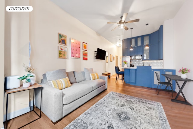 living room with ceiling fan and hardwood / wood-style floors