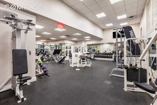 workout area with visible vents and a paneled ceiling