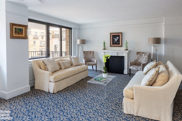 living room with a fireplace and baseboards